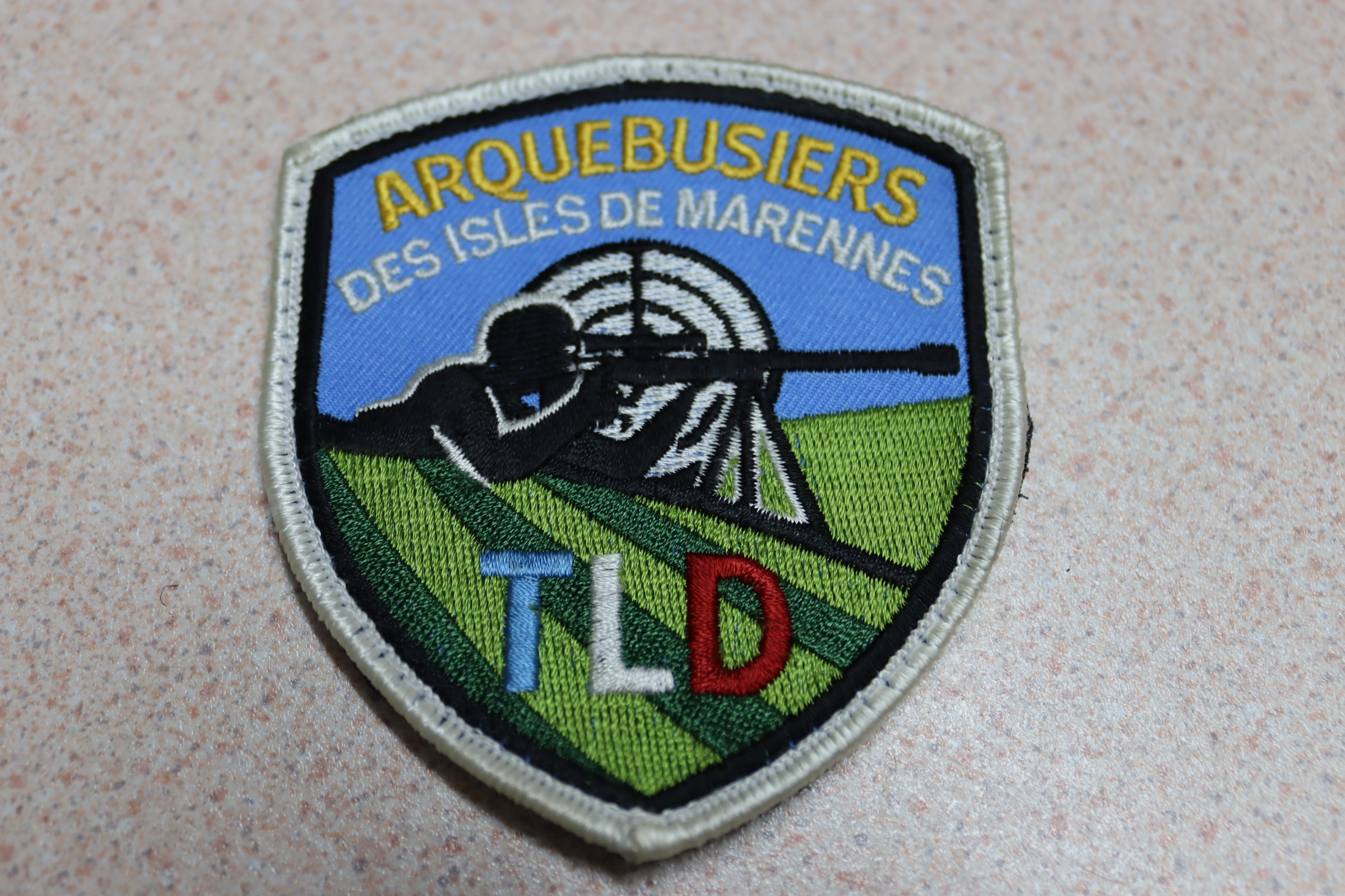 BADGE BRODE TLD